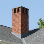 Severely deteriorated brick chimney with shifted bricks, missing mortar, and crumbling masonry — Spring Hill Chimney Service NEPA