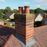 Brick chimney on a residential roof with bold text overlay reading 