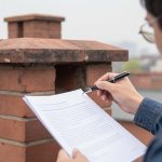 Homeowner reviewing a written chimney inspection report with photographs at a kitchen table — Spring Hill Chimney Service NEPA