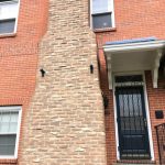 Older brick row home in northeastern Pennsylvania with original masonry chimney showing decades of weathering — Spring Hill Chimney Service NEPA